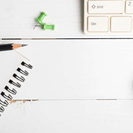 notepad and computer on white table background view from aboveの写真素材