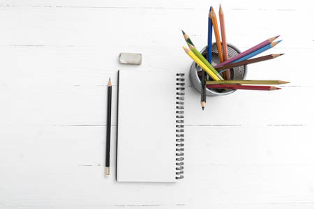 notepad with color pencil on white table view from aboveの写真素材