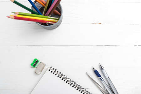 notepad with color pencil on white table view from aboveの写真素材