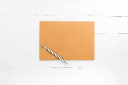 brown paper with pen on white table view from aboveの写真素材