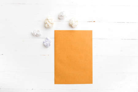 brown paper and crumpled on white table