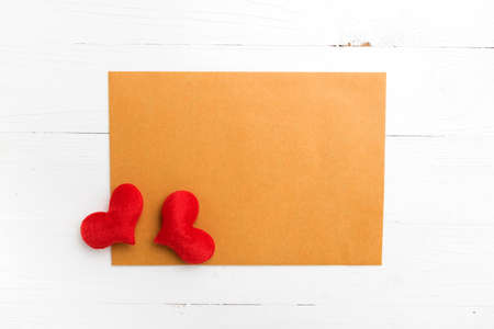 brown paper and heart on white tableの写真素材