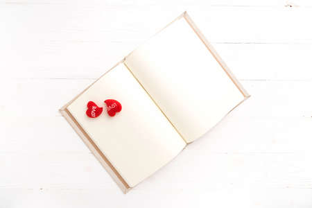 heart on notebook over white tableの写真素材