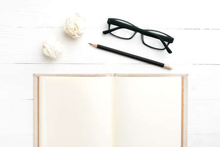 notebook and crumpled paper over white backgroundの写真素材