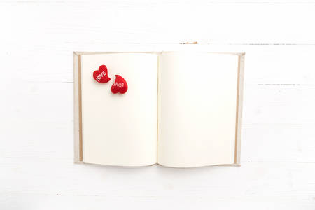 heart on notebook over white tableの写真素材