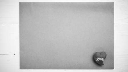 heart on brown paper over white table black and white tone color styleの写真素材