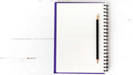 notepad with pen on white tableの写真素材
