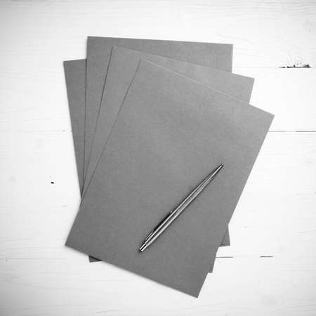 paper with pen on table view from above black and white color styleの写真素材
