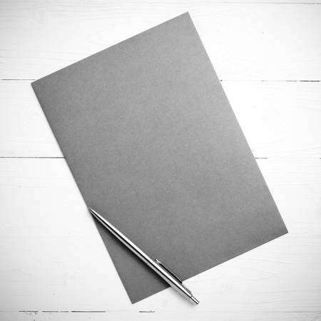 paper with pen on table view from above black and white color styleの写真素材