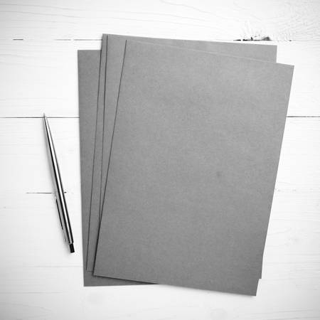 paper with pen on table view from above black and white color styleの写真素材