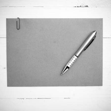 paper with pen on table view from above black and white color styleの写真素材