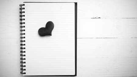 red heart on notepad on white table black and white styleの写真素材