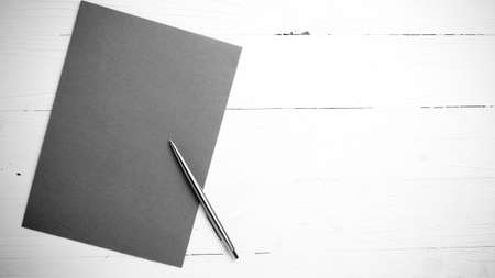 paper with pen on table view from above black and white color styleの写真素材