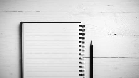 notepad with pen on white table black and white styleの写真素材