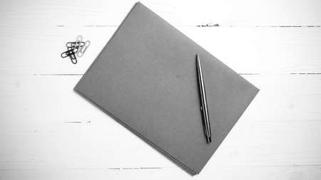 paper with pen on table view from above black and white color styleの写真素材