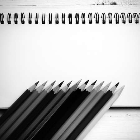 notepad with color pencil on white table view from above black and white color styleの写真素材