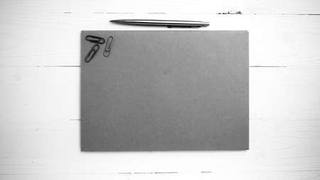 paper with pen on table view from above black and white color style