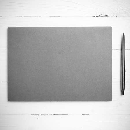 paper with pen on table view from above black and white color styleの写真素材