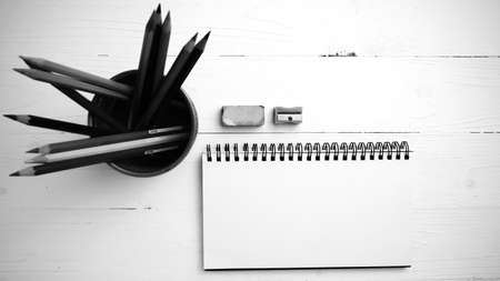 notepad with color pencil on white table view from above black and white color styleの写真素材