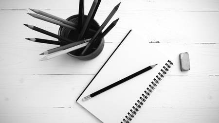notepad with color pencil on white table view from above black and white color styleの写真素材