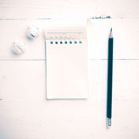notepad with crumpled paper and pencil over white table vintage styleの写真素材