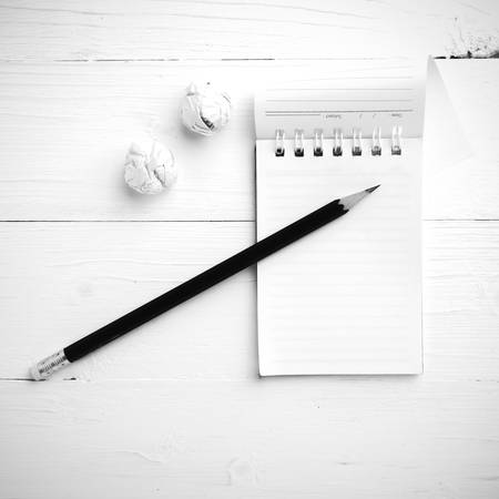 notepad with crumpled paper and pencil over white table black and white tone color styleの写真素材