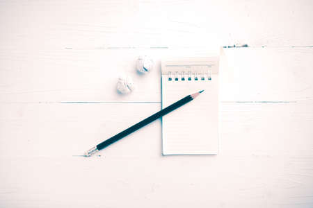 notepad with crumpled paper and pencil over white table vintage styleの写真素材
