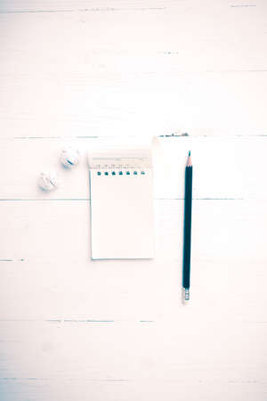 notepad with crumpled paper and pencil over white table vintage styleの写真素材