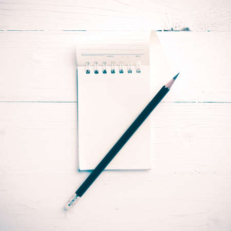 notepad with crumpled paper and pencil over white table vintage styleの写真素材