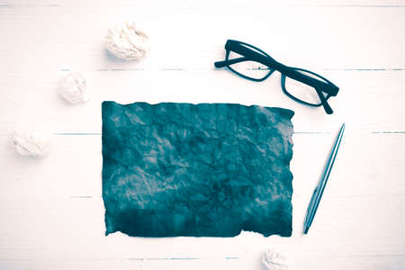 burning brown paper and crumpled paper over white table vintage styleの写真素材