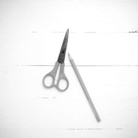 scissors and pencil on table black and white tone color styleの写真素材