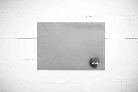 heart on brown paper over white table black and white tone color styleの写真素材