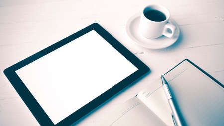 tablet with office supplies over white table vintage style