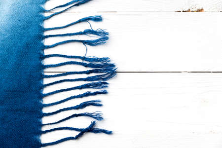 blue scarf over white wood table backgroundの写真素材