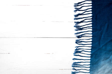blue scarf over white wood table backgroundの写真素材