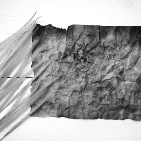 old brown paper and wheat on white table black and white colorの写真素材