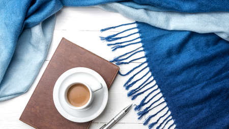 coffee and scarf background on white table