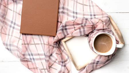 coffee and scarf background on white tableの写真素材