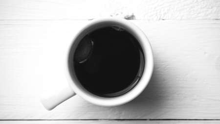 dirty coffee over white table black and white colorの写真素材