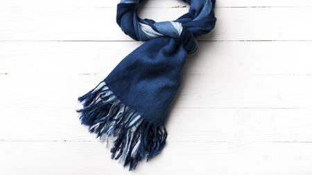 blue scarf over white wood table backgroundの写真素材