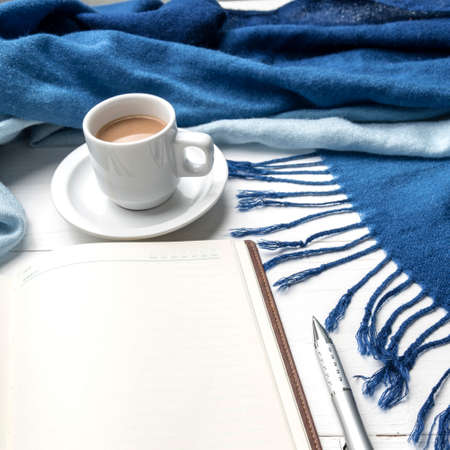 coffee and scarf background on white table