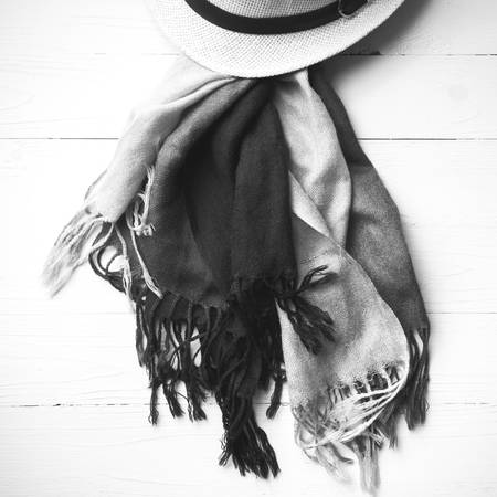 hat and blue scarf on white table black and white colorの写真素材