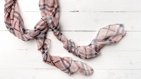 pink scarf over white tableの写真素材