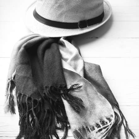 hat and blue scarf on white table black and white colorの写真素材