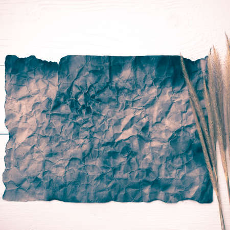 old brown paper and wheat on white table vintage styleの写真素材