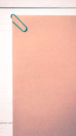 brown paper with green paper clip over white table vintage styleの写真素材