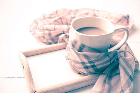 coffee and scarf background on white table vintage styleの写真素材