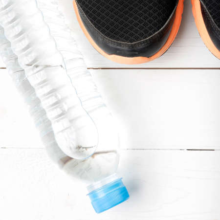 running shoes and drinking water on white tableの写真素材