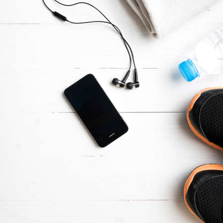 fitness equipment:running shoes,water bottle,towel,smart phone