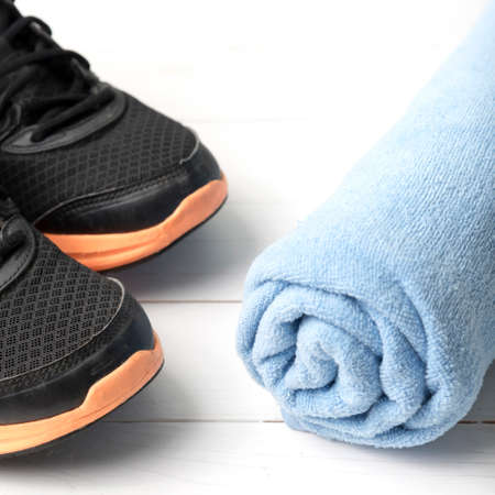running shoes and towel on white wood tableの写真素材